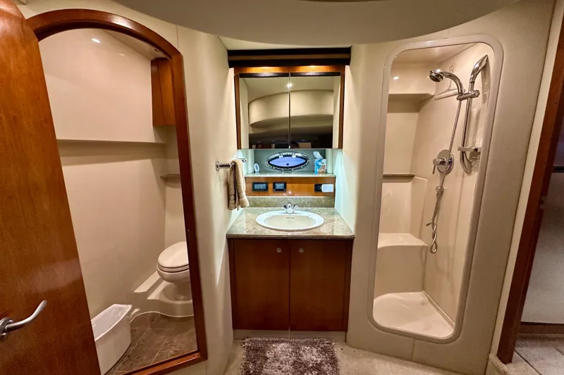 Somewhere With You Yacht Photos Pics Luxurious bathroom in 2009 Cruisers Yachts 460 Express, featuring shower, sink, and toilet.