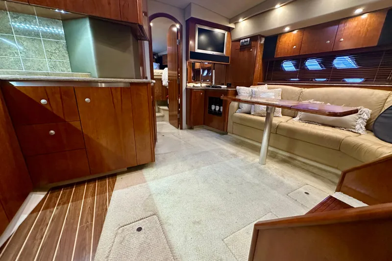 Somewhere With You Yacht Photos Pics Luxurious interior of 2009 Cruisers Yachts 460 Express with elegant wood finishes.