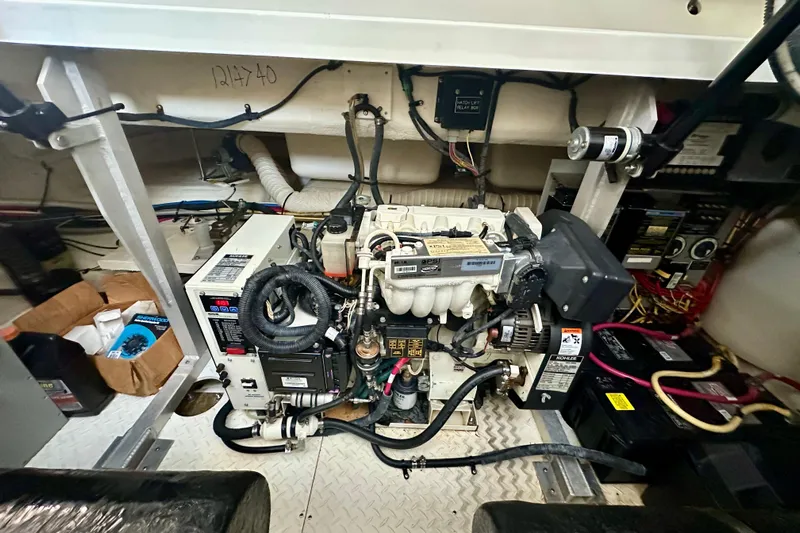 Somewhere With You Yacht Photos Pics Engine room of 2009 Cruisers Yachts 460 Express with visible machinery and wiring.