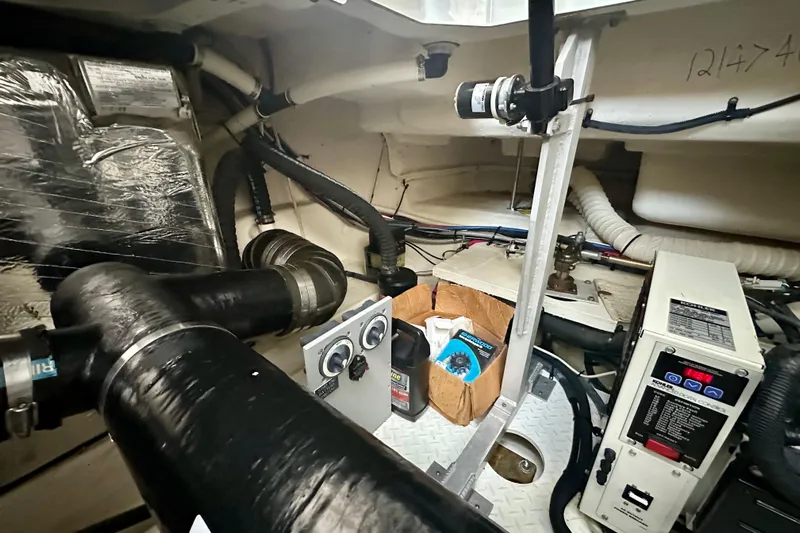 Somewhere With You Yacht Photos Pics Engine room of 2009 Cruisers Yachts 460 Express with control panels and equipment.