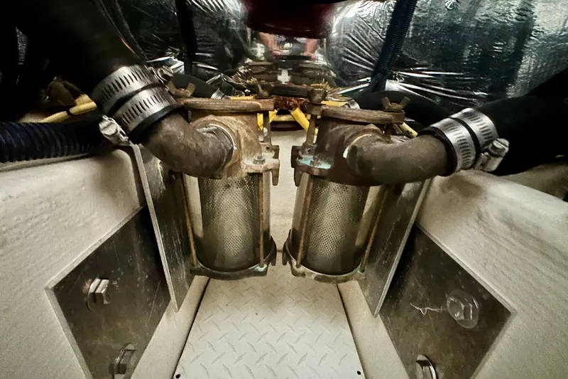 Somewhere With You Yacht Photos Pics Engine room of 2009 Cruisers Yachts 460 Express, featuring dual filters and hoses.