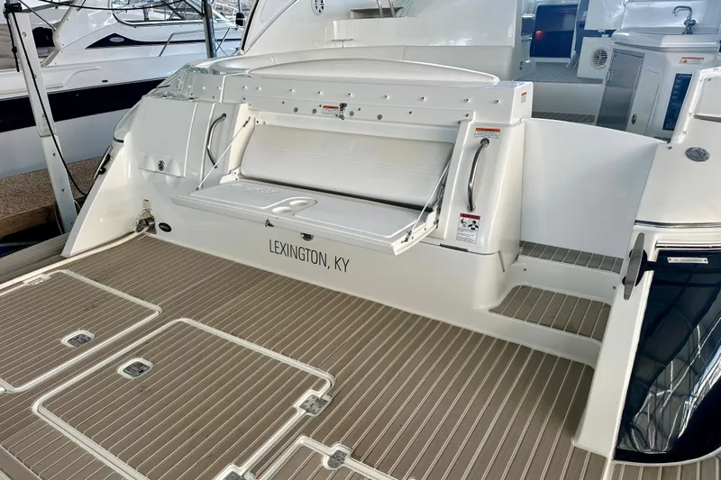 Somewhere With You Yacht Photos Pics 2009 Cruisers Yachts 460 Express boat deck with Lexington, KY inscription.