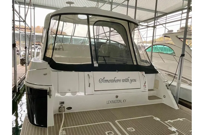 Somewhere With You Yacht Photos Pics 2009 Cruisers Yachts 460 Express docked, rear view with covered cockpit.