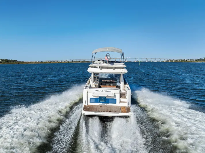 Pure De Papas Yacht Photos Pics Prestige 520 Fly 2019 yacht cruising on open water, leaving a wake behind.