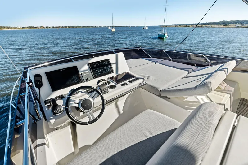 Pure De Papas Yacht Photos Pics 2019 Prestige 520 Fly yacht helm with dual screens and plush seating on open water.