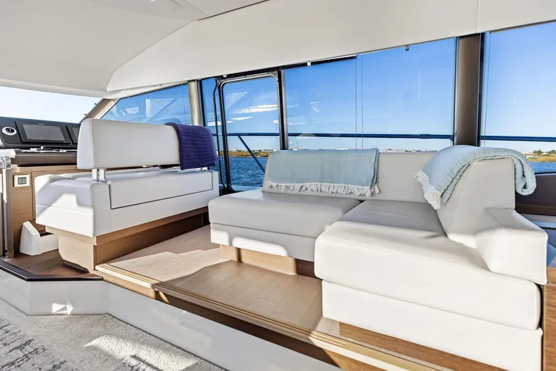Pure De Papas Yacht Photos Pics Luxurious interior of 2019 Prestige 520 Fly yacht with white seating and ocean view.