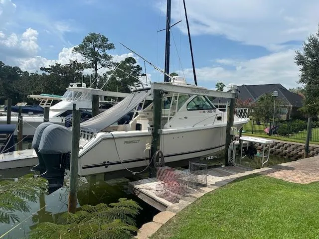  Yacht Photos Pics 2012 Pursuit OS 315 Offshore boat docked in a scenic marina setting.