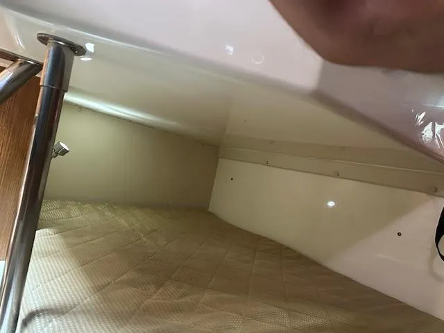  Yacht Photos Pics Interior cabin of 2012 Pursuit OS 315 Offshore boat, featuring a cozy sleeping area.