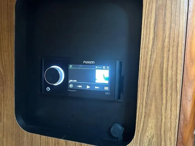  Yacht Photos Pics Fusion audio system in 2012 Pursuit OS 315 Offshore boat, mounted on wooden panel.