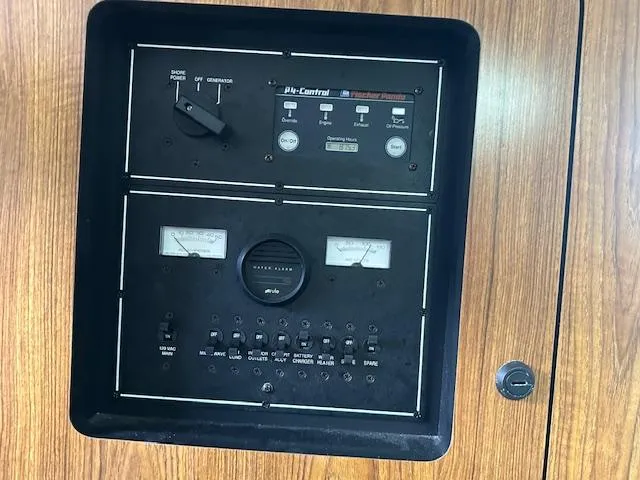  Yacht Photos Pics Control panel of a 2012 Pursuit OS 315 Offshore boat, featuring various switches and gauges.