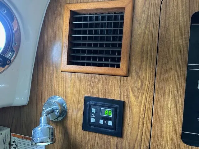  Yacht Photos Pics 2012 Pursuit OS 315 Offshore cabin interior with vent, light, and digital control panel.