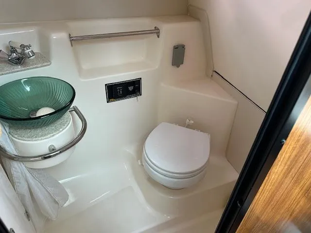  Yacht Photos Pics 2012 Pursuit OS 315 Offshore bathroom with modern sink and toilet.