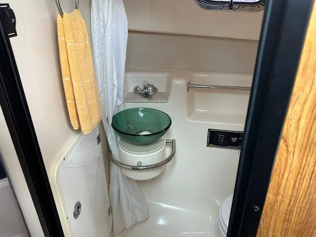  Yacht Photos Pics Bathroom interior of 2012 Pursuit OS 315 Offshore boat with sink and towel.