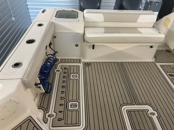  Yacht Photos Pics 2012 Pursuit OS 315 Offshore boat interior with seating and fishing rod holders.