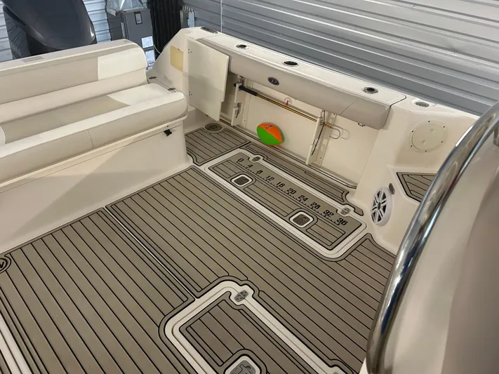  Yacht Photos Pics 2012 Pursuit OS 315 Offshore boat interior with cushioned seating and striped flooring.