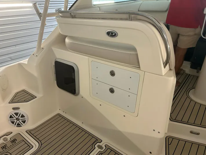  Yacht Photos Pics 2012 Pursuit OS 315 Offshore boat interior with storage compartments and seating.