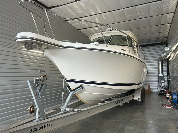  Yacht Photos Pics 2012 Pursuit OS 315 Offshore boat on trailer in storage facility.