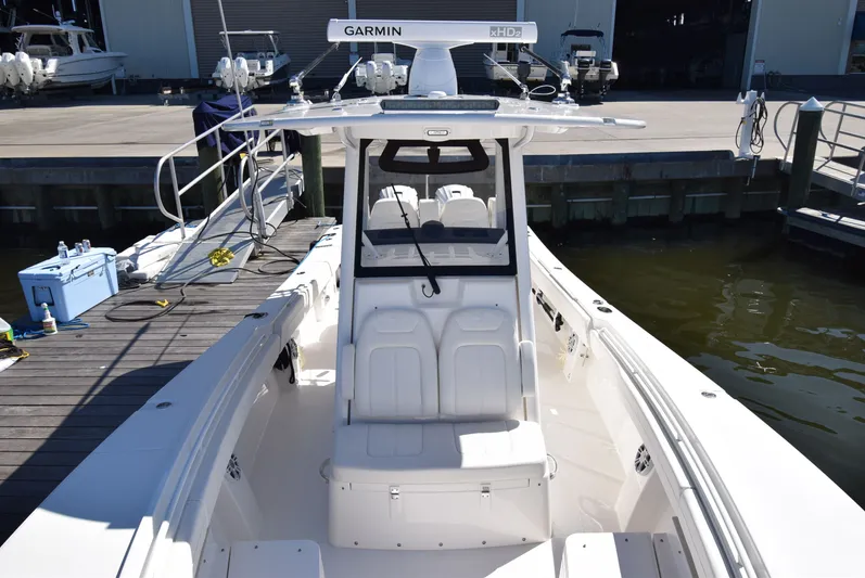 Salty Dog Yacht Photos Pics 2023 Regulator 31 boat docked, featuring Garmin equipment and spacious seating.