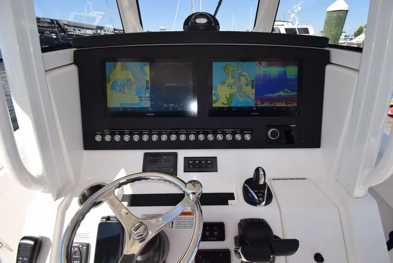 Salty Dog Yacht Photos Pics 2023 Regulator 31 boat dashboard with dual navigation screens and controls.