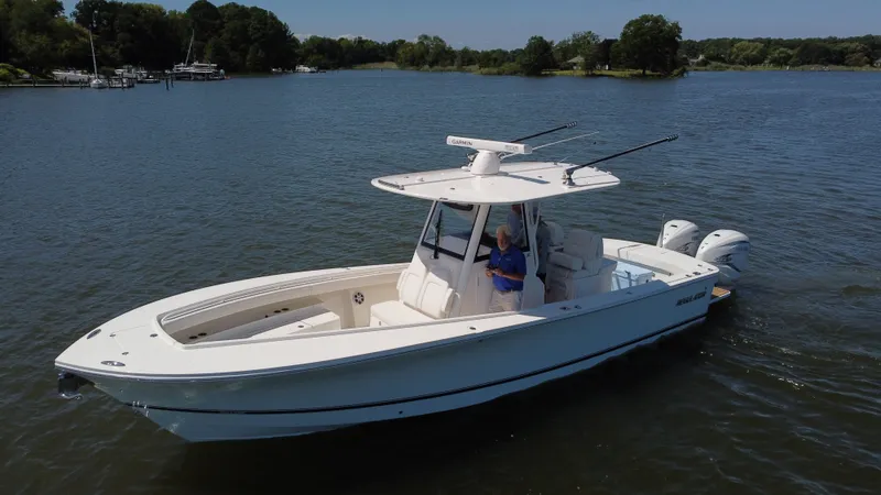 Salty Dog Yacht Photos Pics 2023 Regulator 31 boat on a calm lake with lush green surroundings.