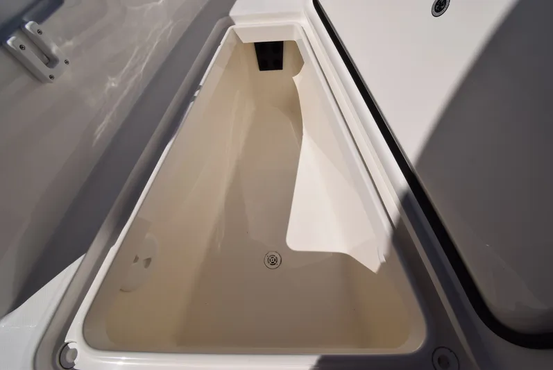 Salty Dog Yacht Photos Pics 2023 Regulator 31 boat storage compartment, open and empty, showcasing interior space.