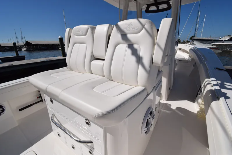 Salty Dog Yacht Photos Pics 2023 Regulator 31 boat with white cushioned seating at a marina.