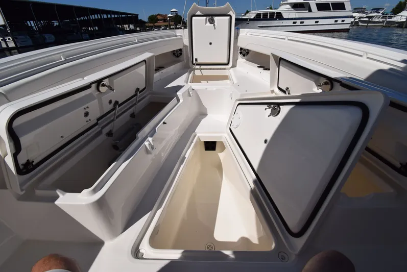 Salty Dog Yacht Photos Pics 2023 Regulator 31 boat interior with open storage compartments at a marina.