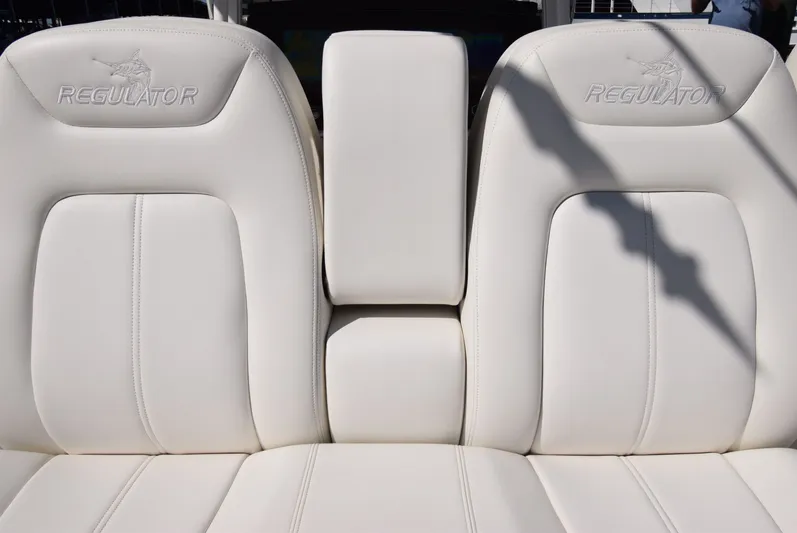 Salty Dog Yacht Photos Pics 2023 Regulator 31 boat seats with embossed logo, white leather upholstery.