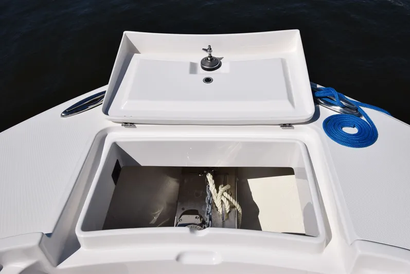 Salty Dog Yacht Photos Pics 2023 Regulator 31 boat anchor storage with rope and blue line on deck.