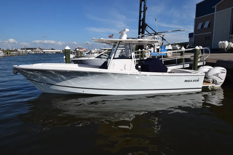 Salty Dog Yacht Photos Pics 2023 Regulator 31 boat docked at marina with clear blue sky.