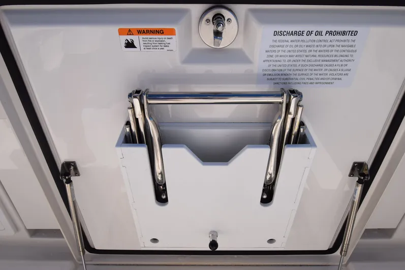 Salty Dog Yacht Photos Pics 2023 Regulator 31 boat ladder with safety and oil discharge warnings.