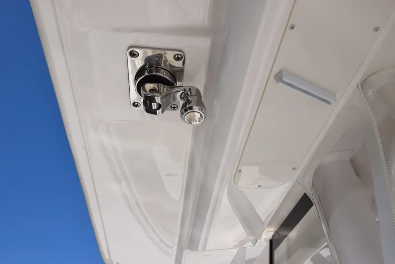 Salty Dog Yacht Photos Pics Chrome fixture on 2023 Regulator 31 boat against clear blue sky.
