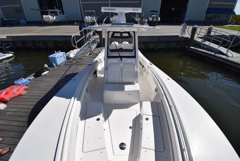 Salty Dog Yacht Photos Pics 2023 Regulator 31 boat docked at marina, featuring spacious deck and modern design.