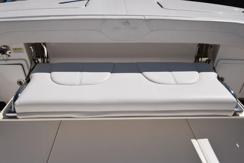 Salty Dog Yacht Photos Pics 2023 Regulator 31 boat with foldable cushioned seat, white and gray upholstery.