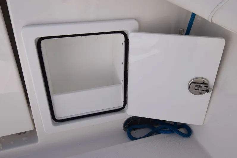 Salty Dog Yacht Photos Pics Open storage compartment on 2023 Regulator 31 boat with blue rope inside.