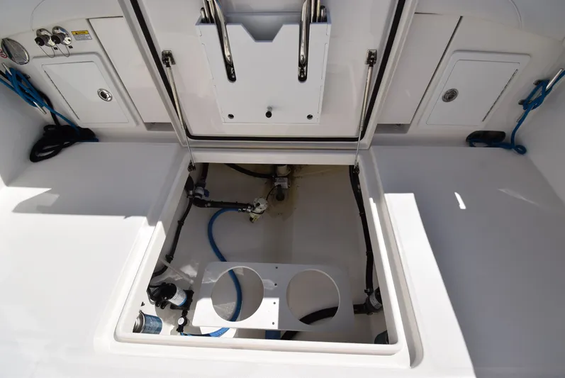 Salty Dog Yacht Photos Pics 2023 Regulator 31 boat storage compartment with open hatch and visible plumbing.
