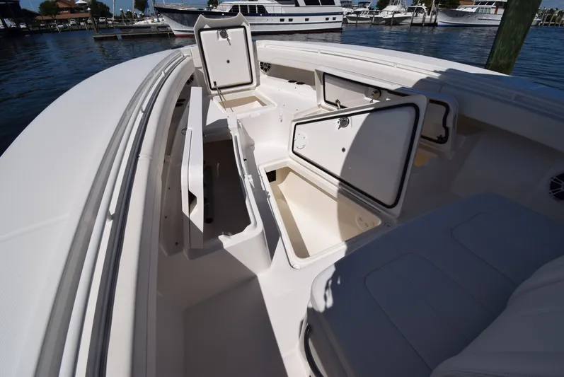 Salty Dog Yacht Photos Pics 2023 Regulator 31 boat with open storage compartments, docked by the water.
