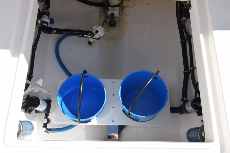 Salty Dog Yacht Photos Pics 2023 Regulator 31 boat interior with blue buckets and plumbing components.
