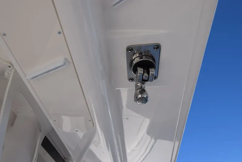 Salty Dog Yacht Photos Pics 2023 Regulator 31 boat detail with chrome fitting against blue sky.