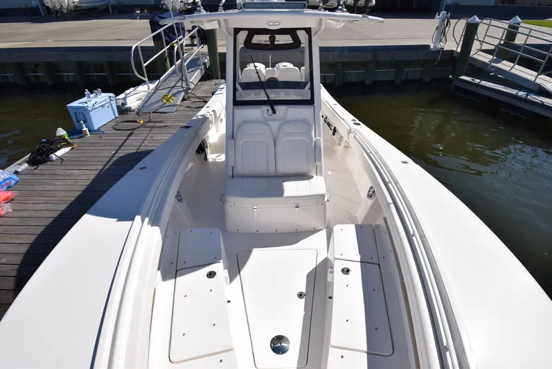 Salty Dog Yacht Photos Pics 2023 Regulator 31 boat docked, showcasing spacious seating and sleek design.