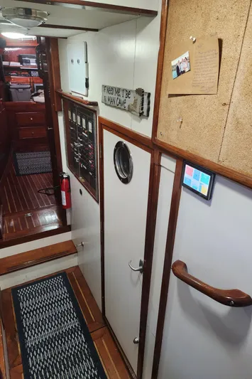 Magic Carpet Yacht Photos Pics 1983 Challenger Custom 60 yacht interior with wooden flooring and nautical decor.