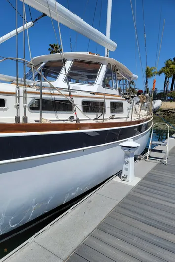 Magic Carpet Yacht Photos Pics 1983 Challenger Custom 60 yacht docked at marina under clear blue sky.