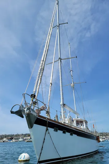 Magic Carpet Yacht Photos Pics Sailing yacht Challenger Custom 60, 1983 model, anchored in a sunny harbor.