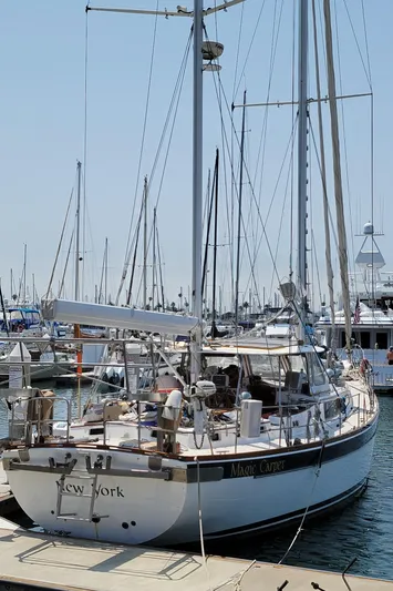 Magic Carpet Yacht Photos Pics 1983 Challenger Custom 60 sailboat docked in marina, clear sky, multiple boats in background.