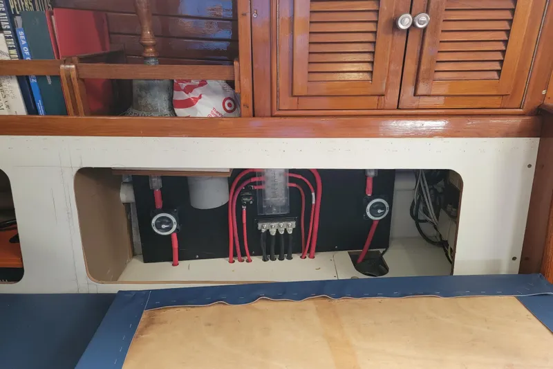 Magic Carpet Yacht Photos Pics Electrical panel with red wires in a 1983 Challenger Custom 60 boat interior.