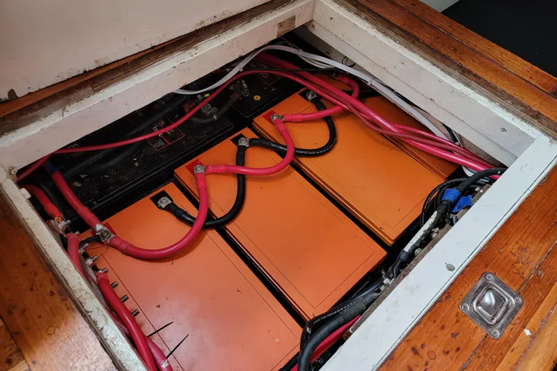 Magic Carpet Yacht Photos Pics Battery compartment of 1983 Challenger Custom 60 with red cables and orange battery units.