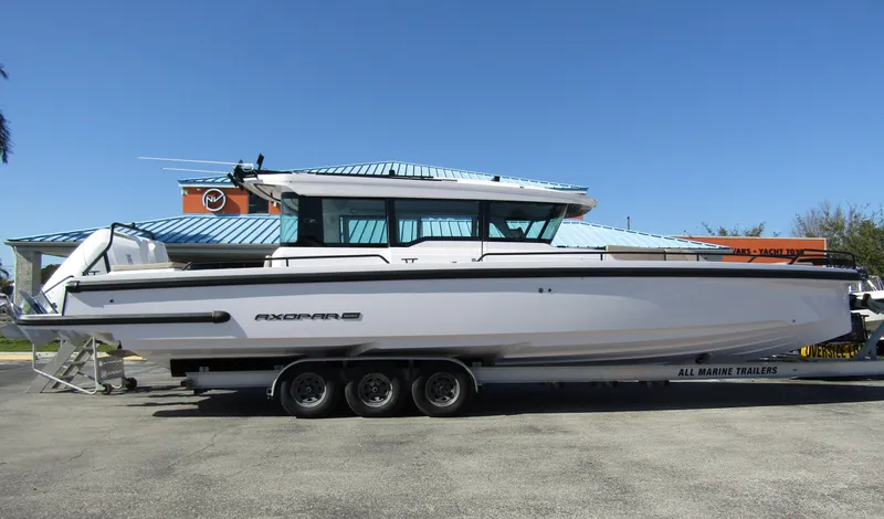  Yacht Photos Pics 2025 Axopar 37XC CROSS CABIN boat on trailer, side view.