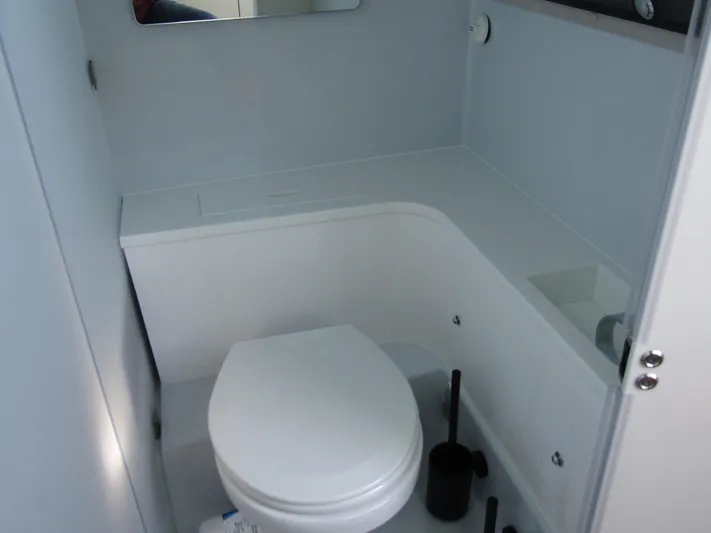  Yacht Photos Pics 2025 Axopar 37XC CROSS CABIN bathroom with modern white toilet and sleek design.