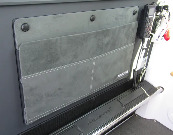  Yacht Photos Pics 2025 Axopar 37XC CROSS CABIN interior with communication equipment and storage panel.