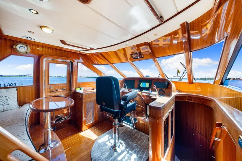 Gypsy Spirit Yacht Photos Pics Luxurious 2007 Hampton 558 Pilothouse interior with polished wood and panoramic windows.